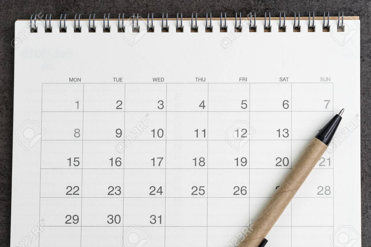 clean and clear calendar with pen on black background using vacation planning calendars
