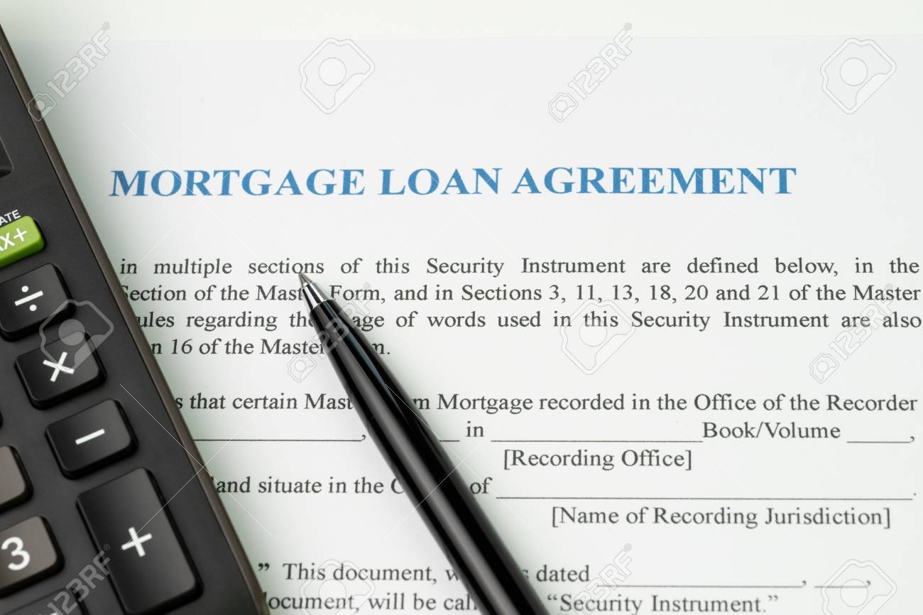 mortgage loan agreement sign contract concept pen with calculator how to calculate a mortgage loan