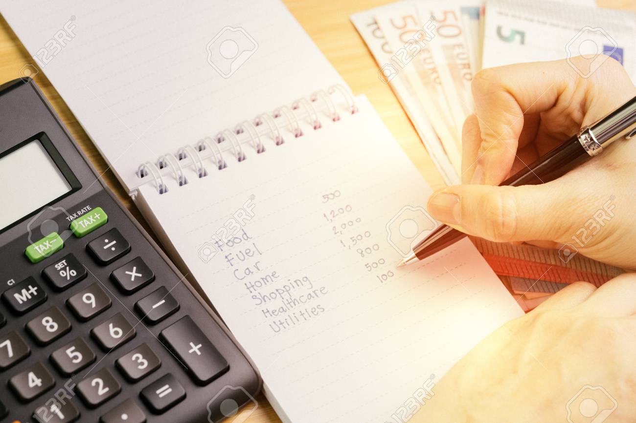 expense calculation or personal finance concept hand holding personal expense calculator