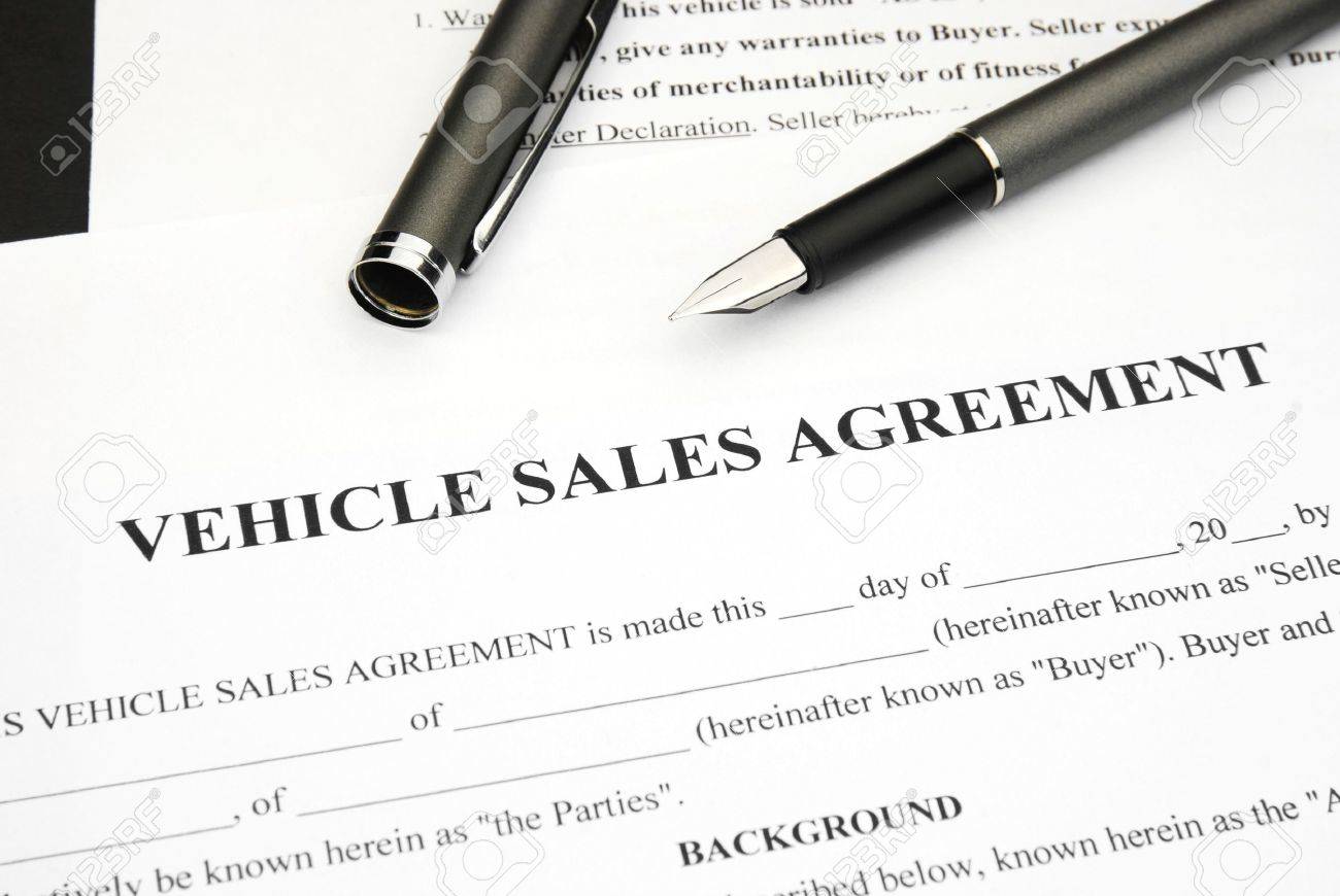 vehicle sales agreement document form with pen stock photo picture