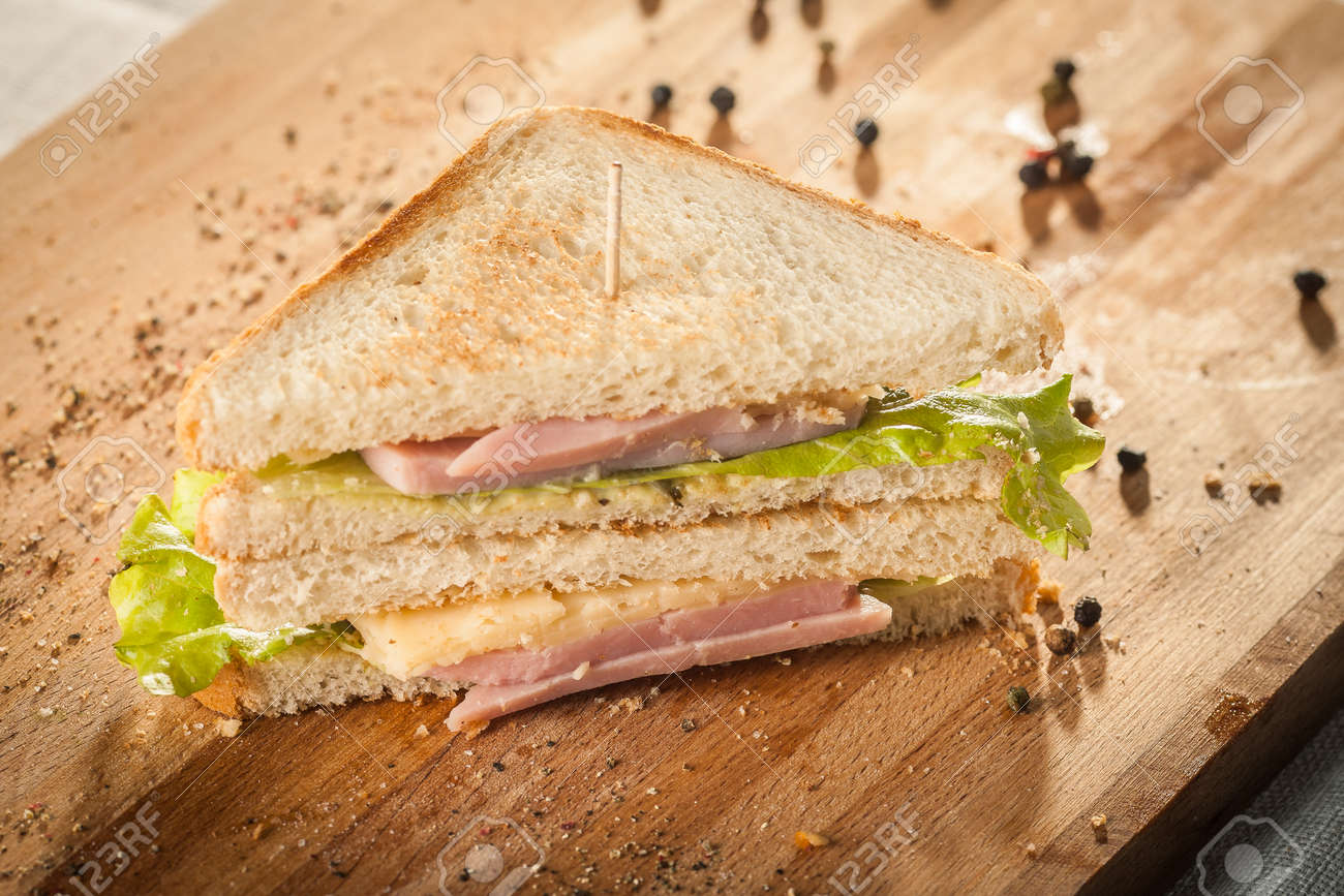 Cut by half sandwich with cheese, salad and ham. - 172306656 Cut by half sandwich with cheese, salad and ham. - 172306656