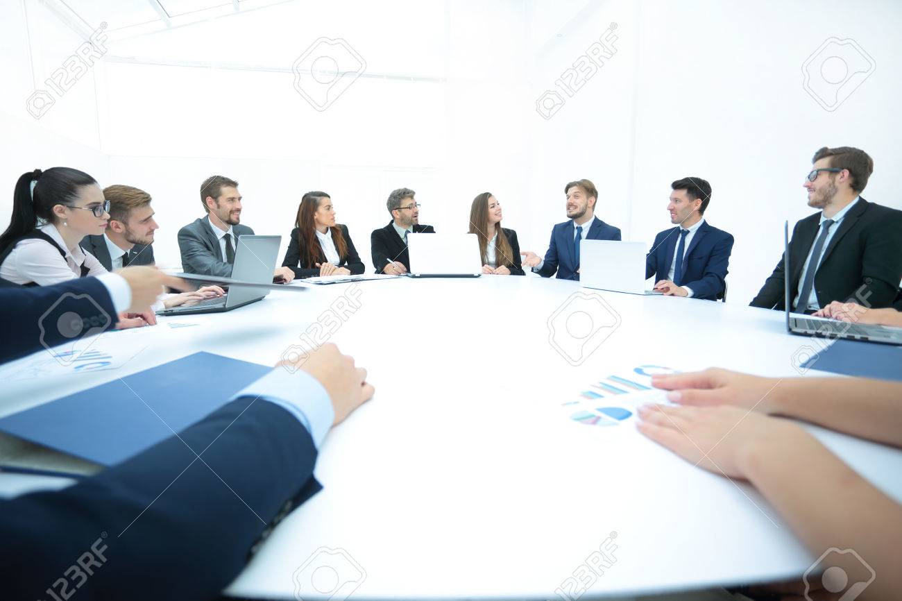 Business conference. Business meeting. Business people in formalwear discussing something while sitting together at the round table - 66014803 Business conference. Business meeting. Business people in formalwear discussing something while sitting together at the round table - 66014803