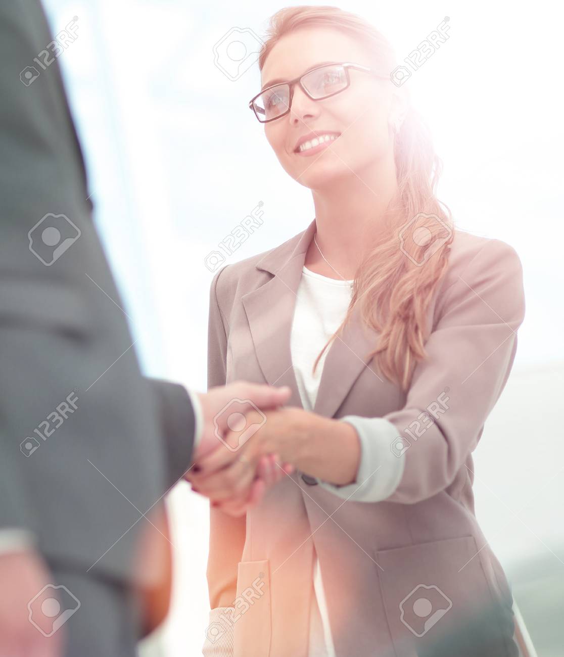 Business partners shaking hands in the modern office - 92930280 Business partners shaking hands in the modern office - 92930280