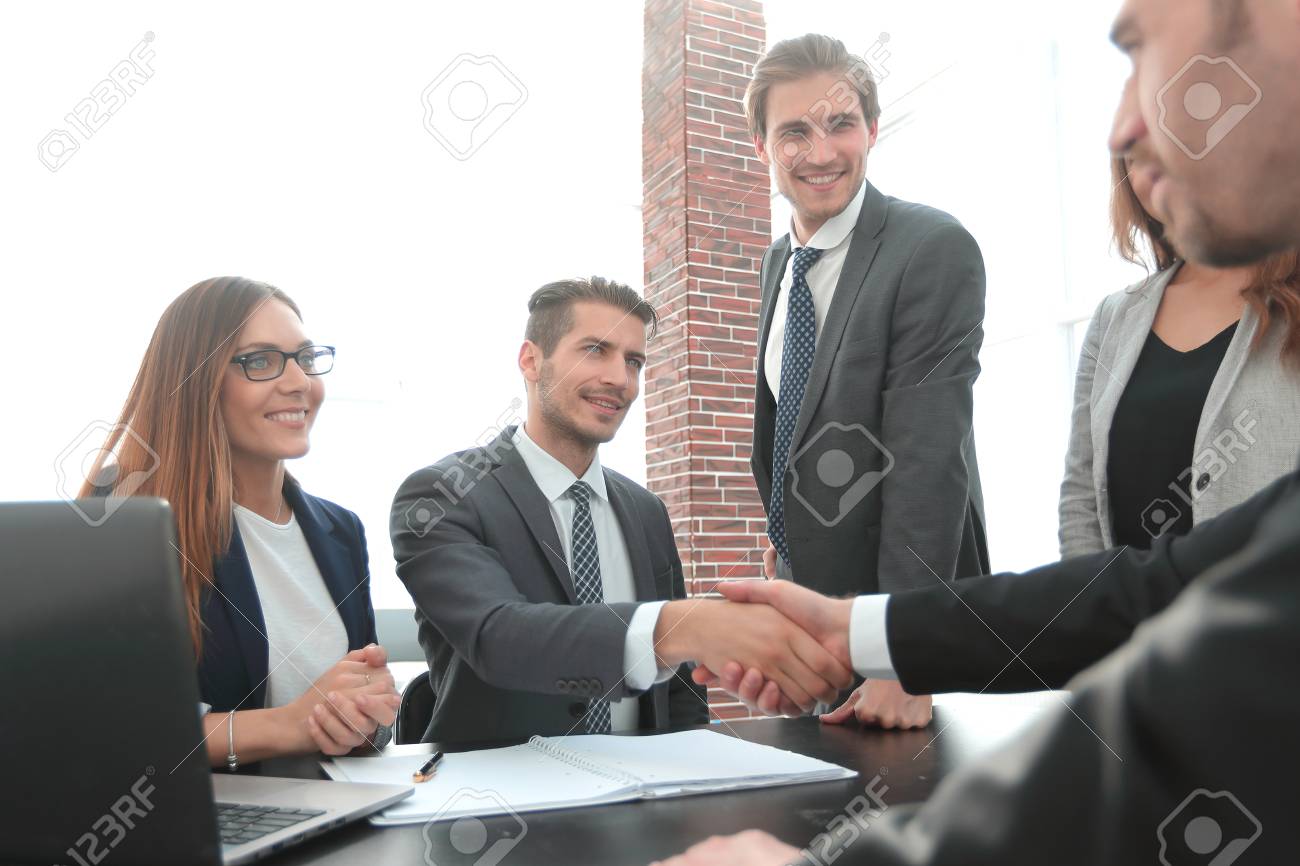 shaking hands after a business meeting in the office - 115186336 shaking hands after a business meeting in the office - 115186336