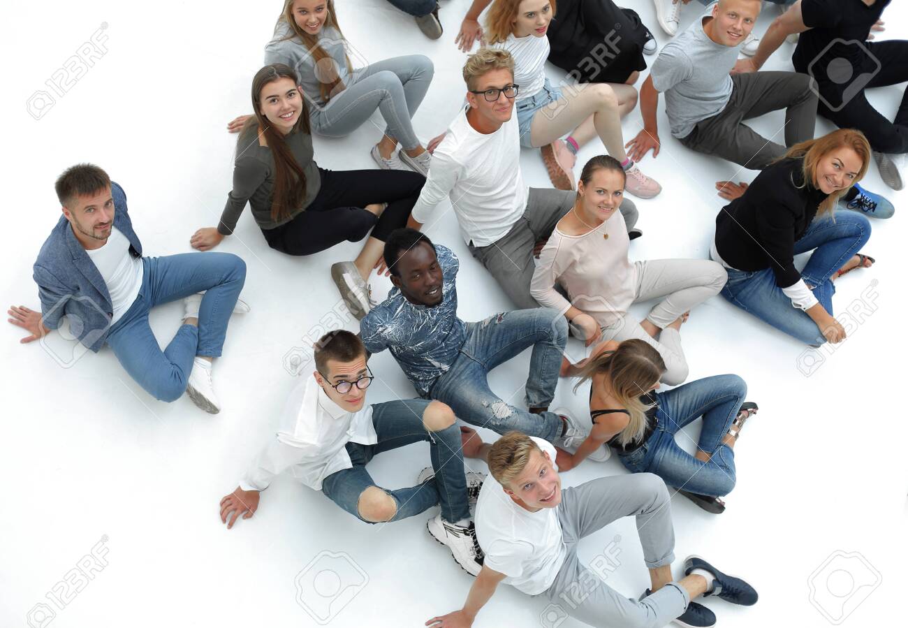 group of young people sitting on the floor and looking at the camera. - 141529404 group of young people sitting on the floor and looking at the camera. - 141529404