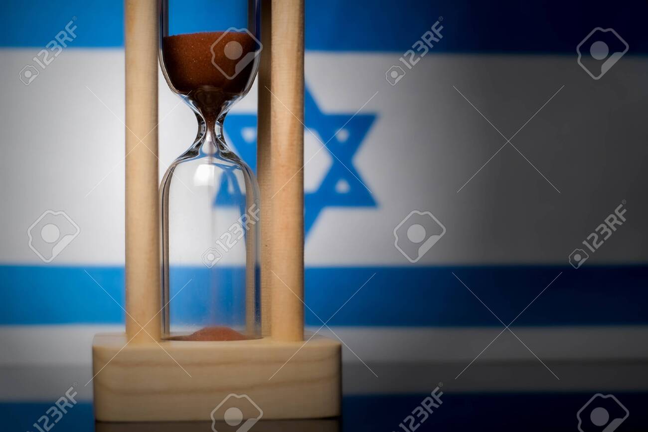 Hourglass and Israel flag, soft focus, copy space - 152379279 Hourglass and Israel flag, soft focus, copy space - 152379279