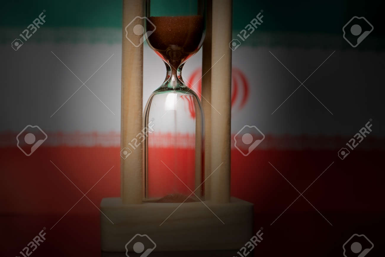 Hourglass and Iran flag, soft focus, copy space - 152379280 Hourglass and Iran flag, soft focus, copy space - 152379280