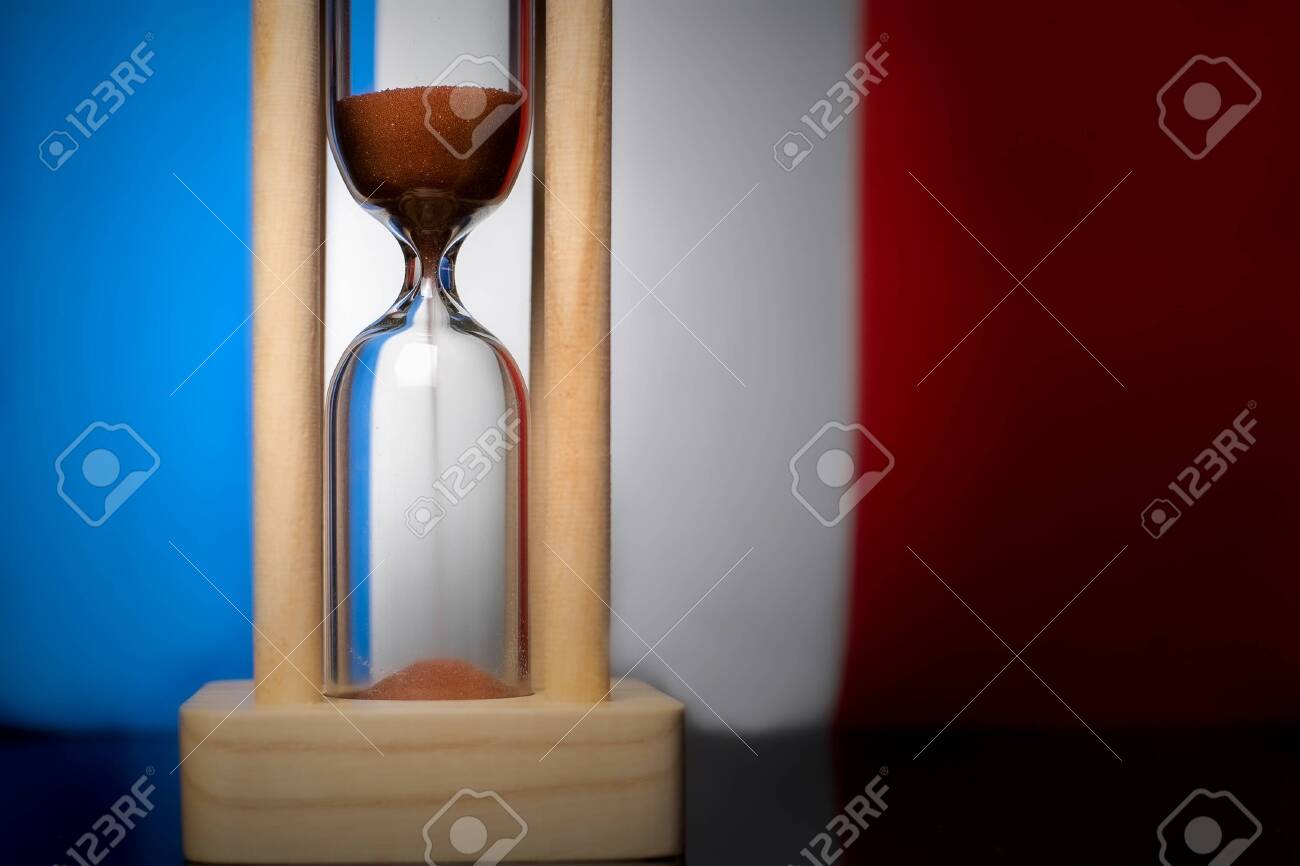 Hourglass and France flag, soft focus, copy space - 152379484 Hourglass and France flag, soft focus, copy space - 152379484