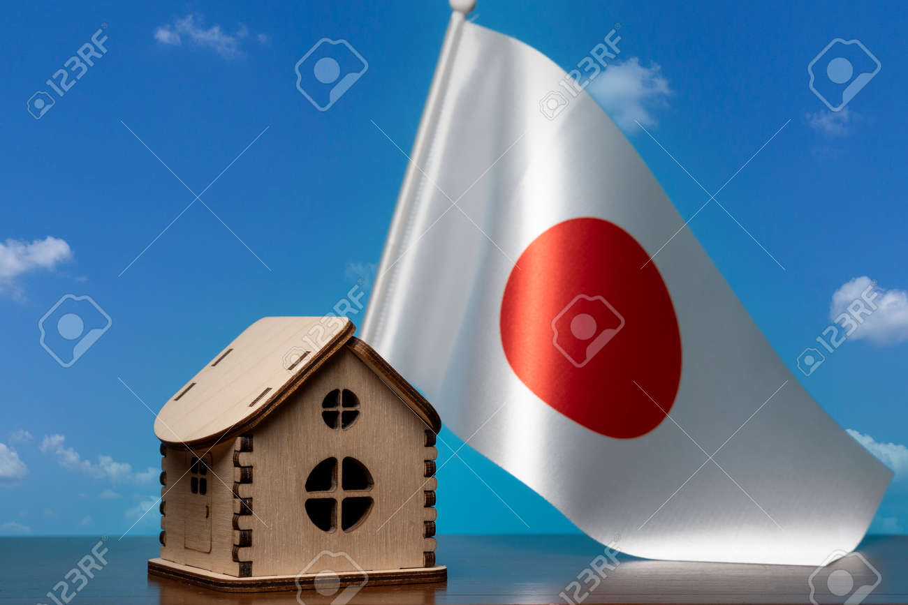 Small wooden house and Japan flag, sky on background. Real estate concept, copy space - 163114078 Small wooden house and Japan flag, sky on background. Real estate concept, copy space - 163114078
