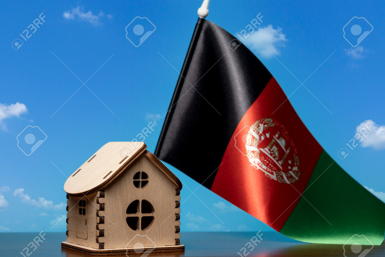 Small wooden house and Afghanistan flag, sky on background. Real estate concept, copy space - 163114086 Small wooden house and Afghanistan flag, sky on background. Real estate concept, copy space - 163114086