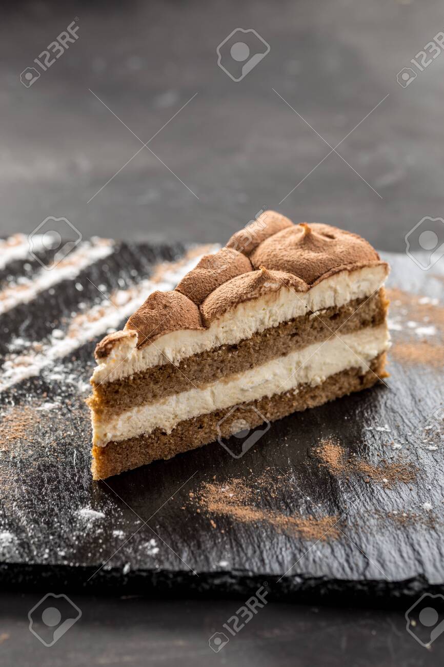 Slice Of Tiramisu Cake On Stone Board On Black Background Side Stock Photo Picture And Royalty Free Image Image
