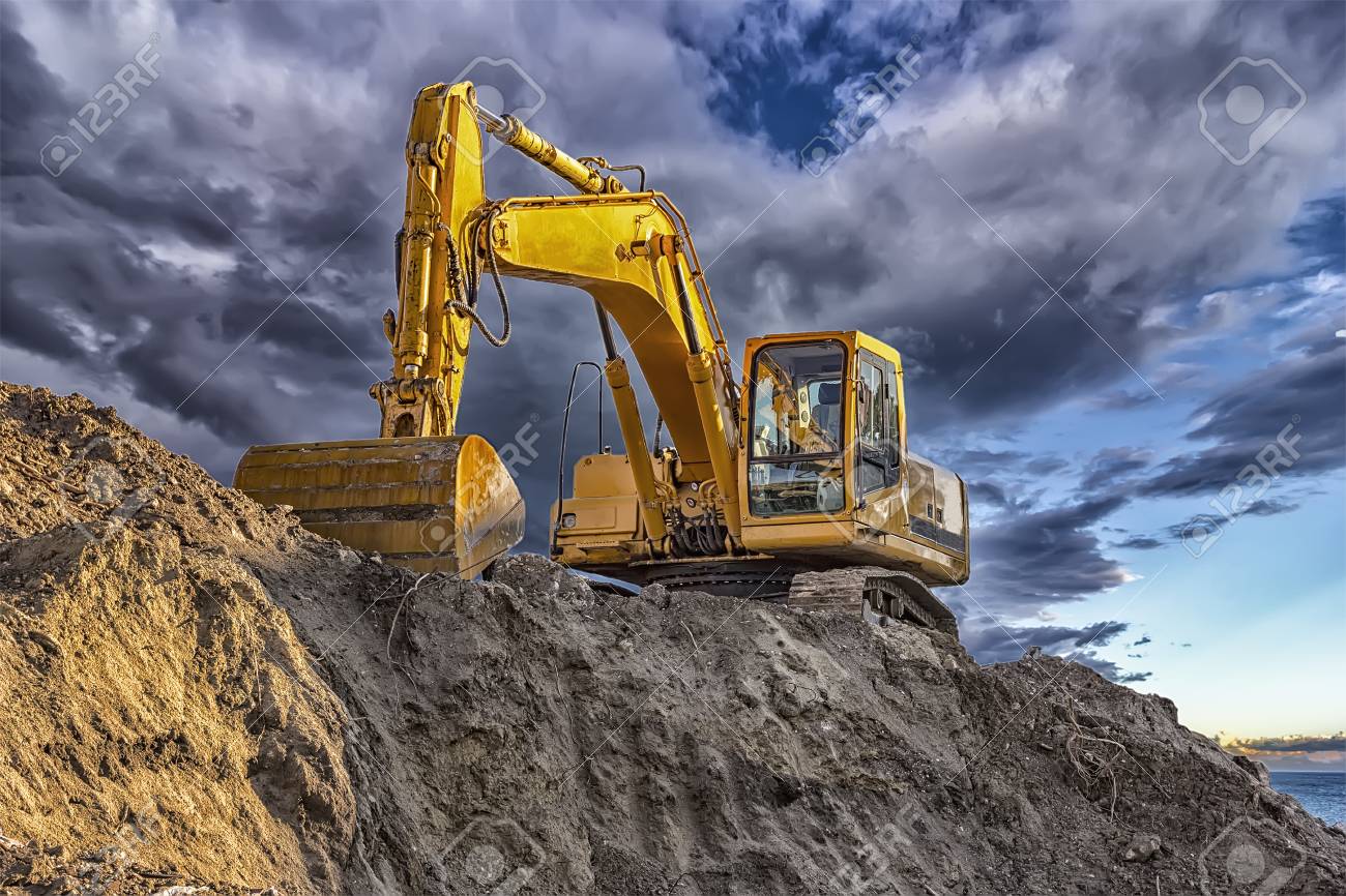 A stopping yellow excavator at an incredibly beautiful sunset - 92680591 A stopping yellow excavator at an incredibly beautiful sunset - 92680591