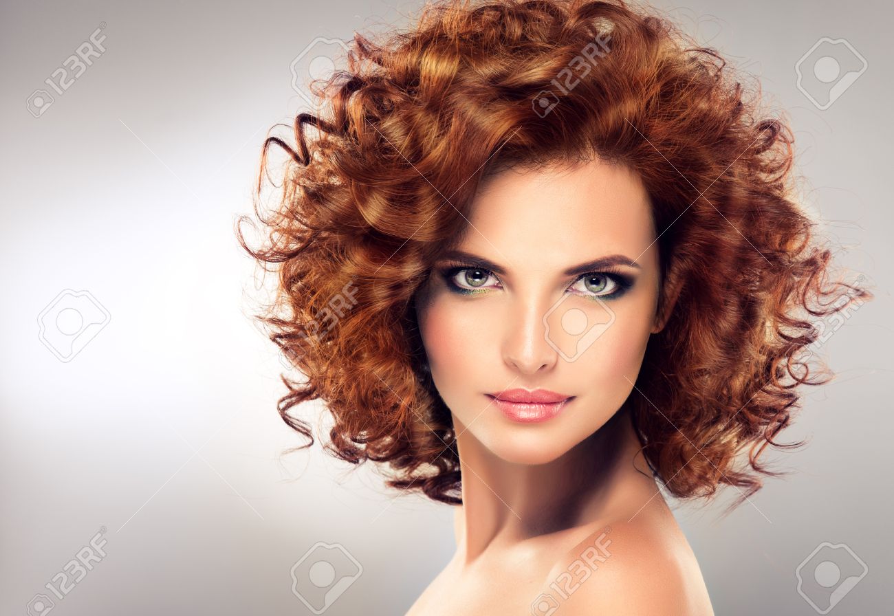 Pretty red haired girl with curls , fashionable makeup. Straight look on camera. - 52034935 Pretty red haired girl with curls , fashionable makeup. Straight look on camera. - 52034935