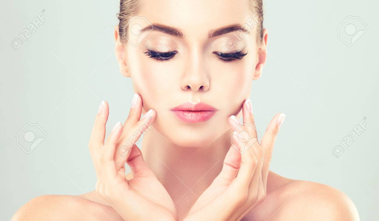 Close-up portrait of young woman with clean fresh skin. Make-up and manicure. - 58233014 Close-up portrait of young woman with clean fresh skin. Make-up and manicure. - 58233014