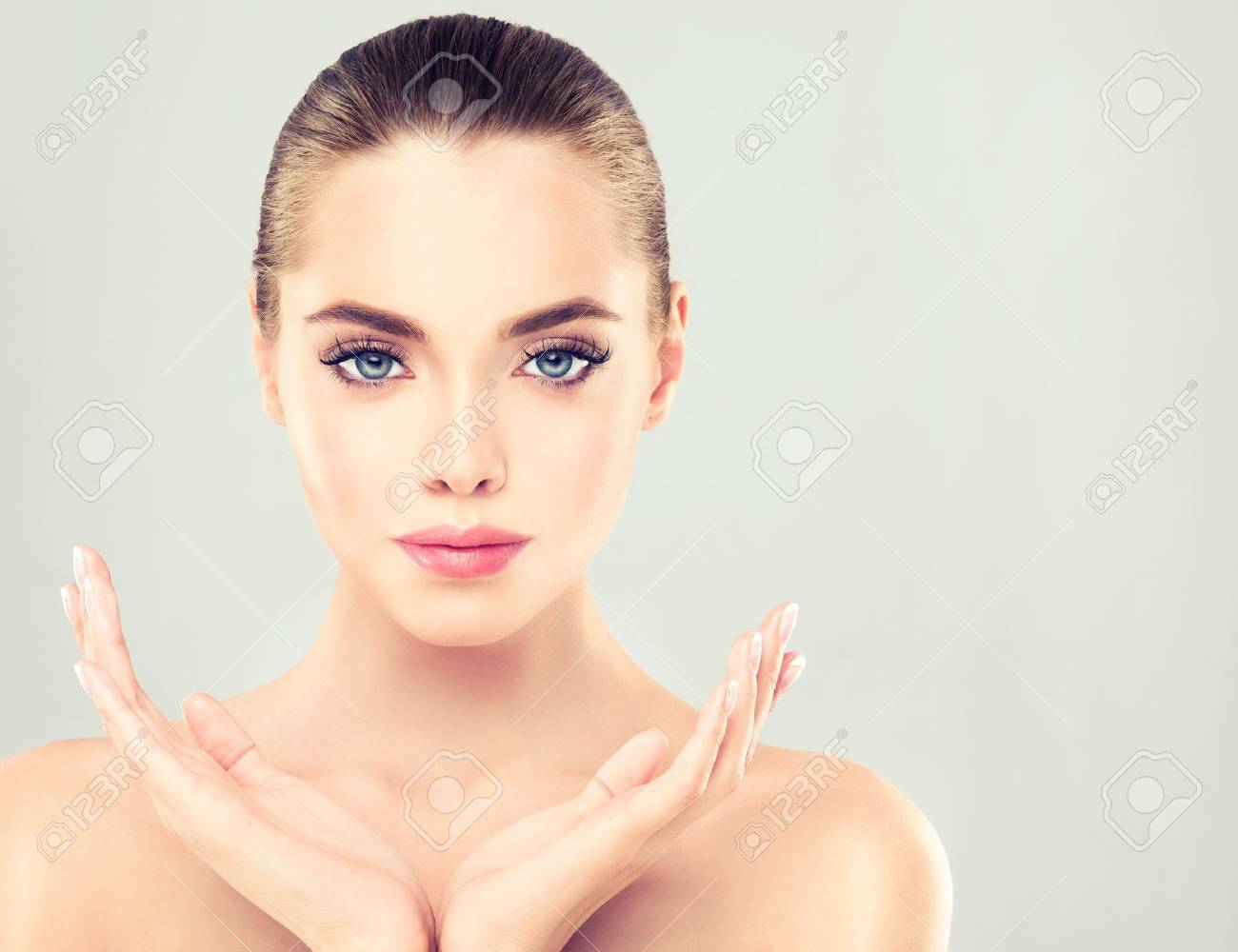 Close-up portrait of young woman with clean fresh skin. Make-up and manicure. - 58233019 Close-up portrait of young woman with clean fresh skin. Make-up and manicure. - 58233019
