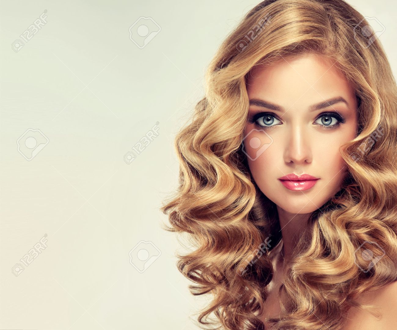 Beautiful girl blonde. Hair with an elegant hairstyle, wavy hair , curly hairstyle .Straight look on camera. - 58420512 Beautiful girl blonde. Hair with an elegant hairstyle, wavy hair , curly hairstyle .Straight look on camera. - 58420512