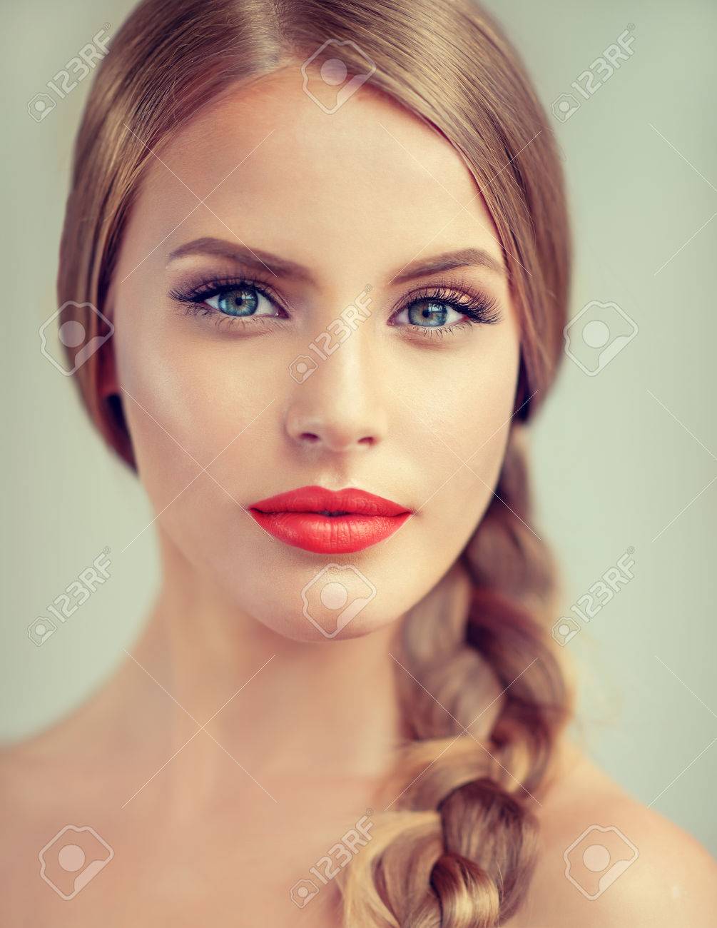 Close up portrait of beautiful young woman with braid(pigtail), bright red lips and blue eyes. Fashion ,beauty and cosmetic. - 70488815 Close up portrait of beautiful young woman with braid(pigtail), bright red lips and blue eyes. Fashion ,beauty and cosmetic. - 70488815