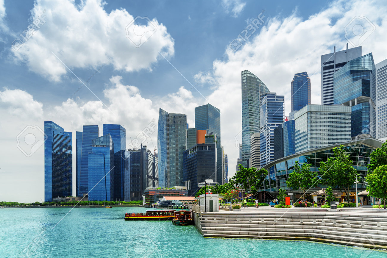 ダウンタウンとシンガポールのマリーナ湾の紺碧水で高層ビルを一望 青い空を背景に近代的な高層ビル 桟橋から観光船 美しい夏の街並み の写真素材 画像素材 Image