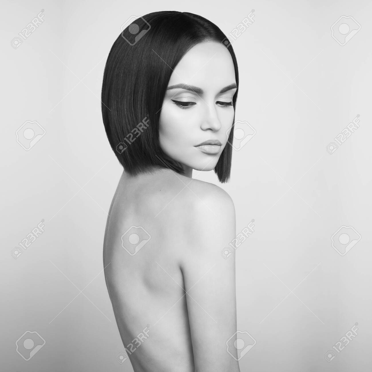 Art Fashion Studio Portrait Of Beautiful Brunette With Short Haircut. Young  Sexy Model Pose In White Studio With Naked Body. Nude Lady With Classic  Professional Make-up Stock Photo, Picture and Royalty Free
