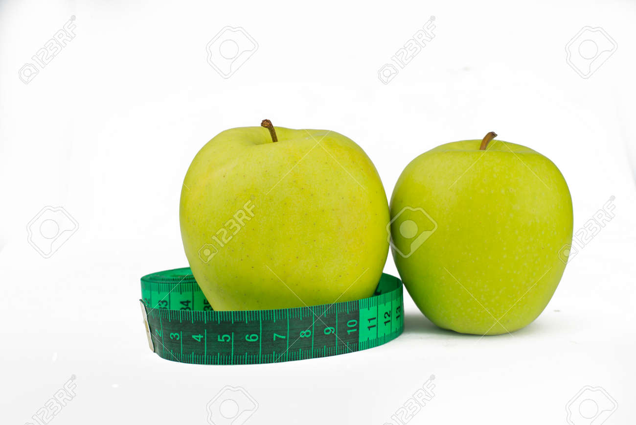 green apples with measuring centimeter for weight control and health and diet on a white background - 163505585 green apples with measuring centimeter for weight control and health and diet on a white background - 163505585