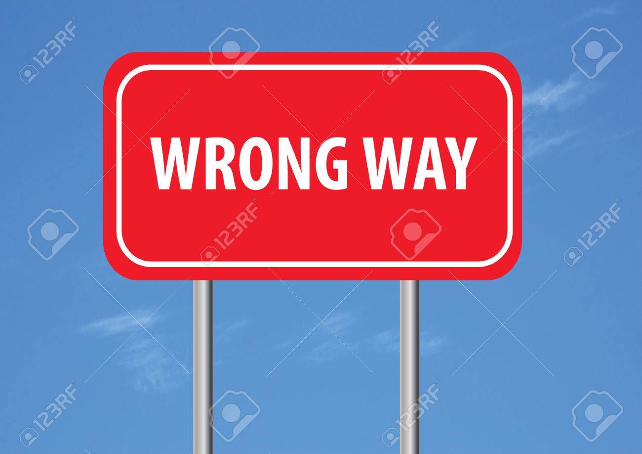 wrong way sign with sky in the background stock photo picture and