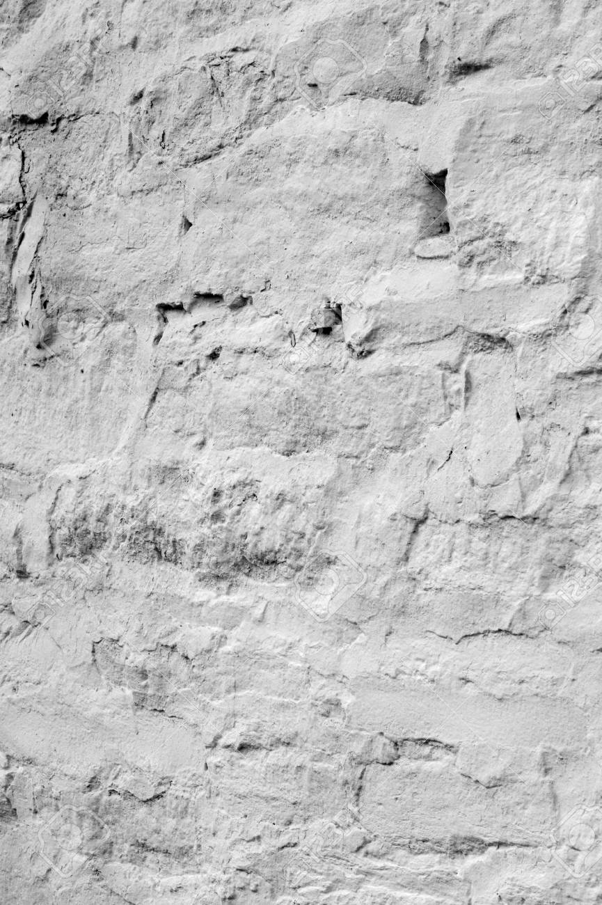 texture background a wall lined with stone whitewashed stock
