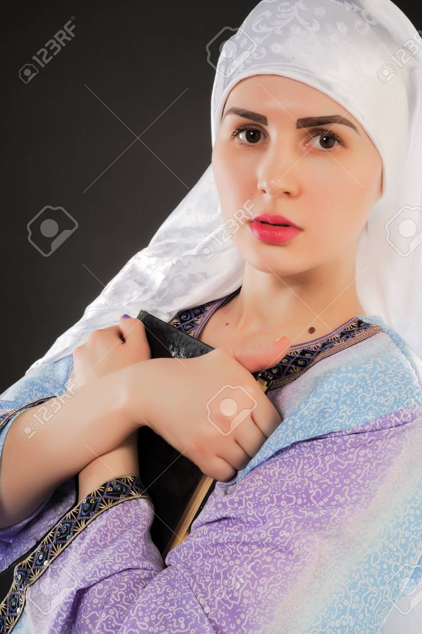 beautiful girl, a Muslim. wearing a hijab. Image of Muslim girl is holding