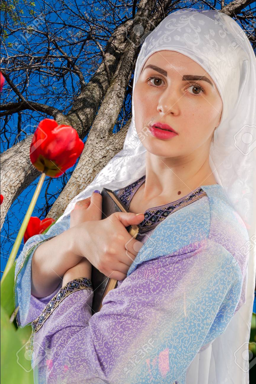 beautiful girl, a Muslim. wearing a hijab. Image of Muslim girl is holding