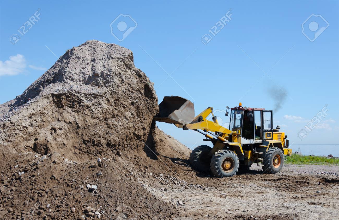 Wheel excavator digging gravel pile for loading in the truck - 95195740 Wheel excavator digging gravel pile for loading in the truck - 95195740