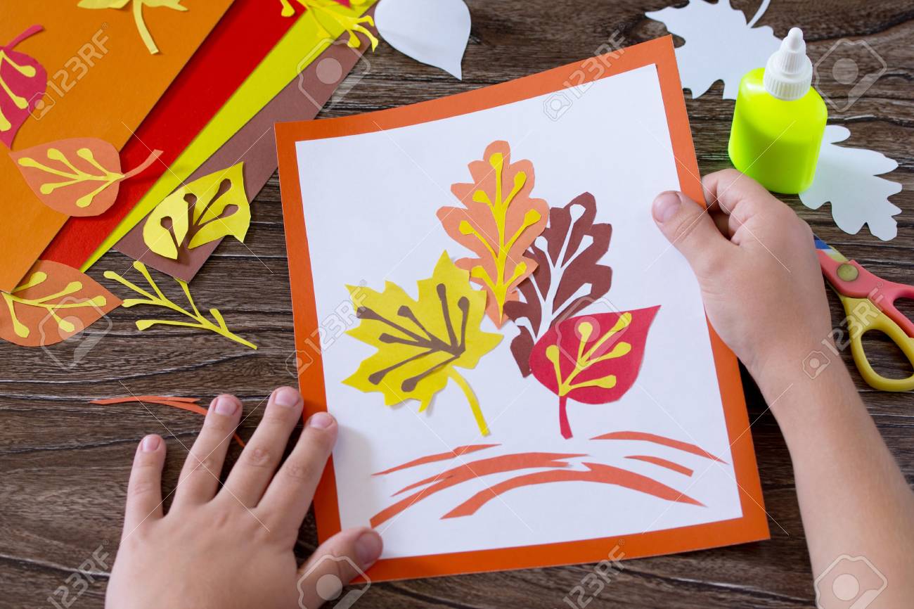 Autumn Leaves Of Colored Paper On A Wooden Background Sheets Crafts For Kids Autumn Leaves Of Colored Paper On A Wooden Background Sheets Crafts For Kids