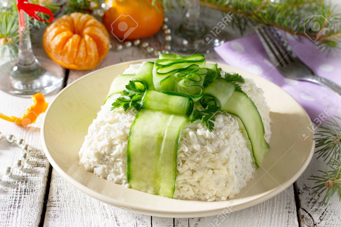 Salad with meat and mushrooms, cucumber decoration bow on a Christmas table. - 63299643 Salad with meat and mushrooms, cucumber decoration bow on a Christmas table. - 63299643