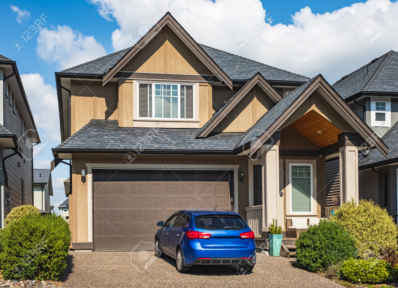 Elegant Detached House And Garage. Big Family House With Garage Car Parked  In Front. Residential House With Concrete Driveway And Entrance Door.  Custom Built Luxury House In A Residential Neighborhood Stock Photo,, image size:1300x943