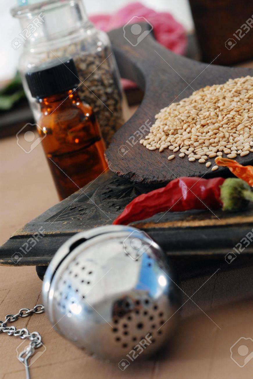 Some of the basic elements of Ayurveda: sesame, chili, tincture, tea ball, and herbs. - 2113603 Some of the basic elements of Ayurveda: sesame, chili, tincture, tea ball, and herbs. - 2113603
