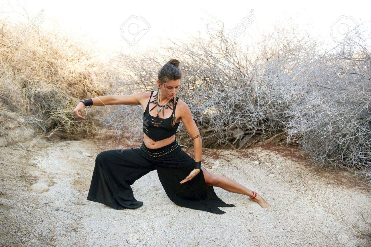 Woman with beautiful style practicing Tai chi in a natural desert environment. Art Medicine Adornment. - 6862790 Woman with beautiful style practicing Tai chi in a natural desert environment. Art Medicine Adornment. - 6862790