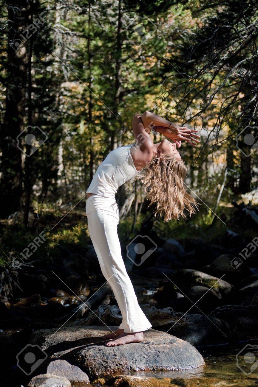 Semi silhouette of Woman in yoga pose outdoors in the wods - 17162532 Semi silhouette of Woman in yoga pose outdoors in the wods - 17162532