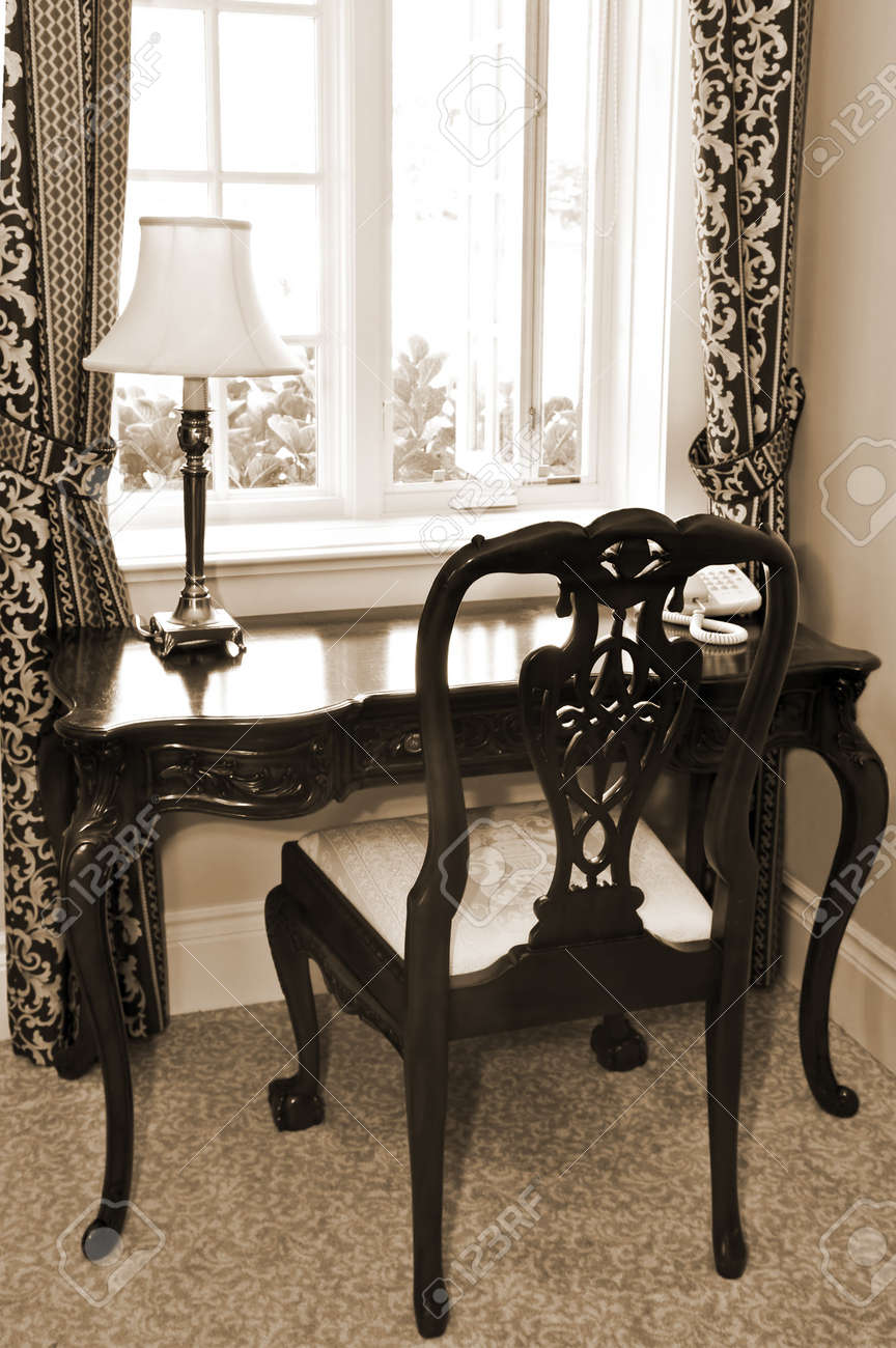 Antique Chair And Desk Near The Window In Living Room Stock Photo