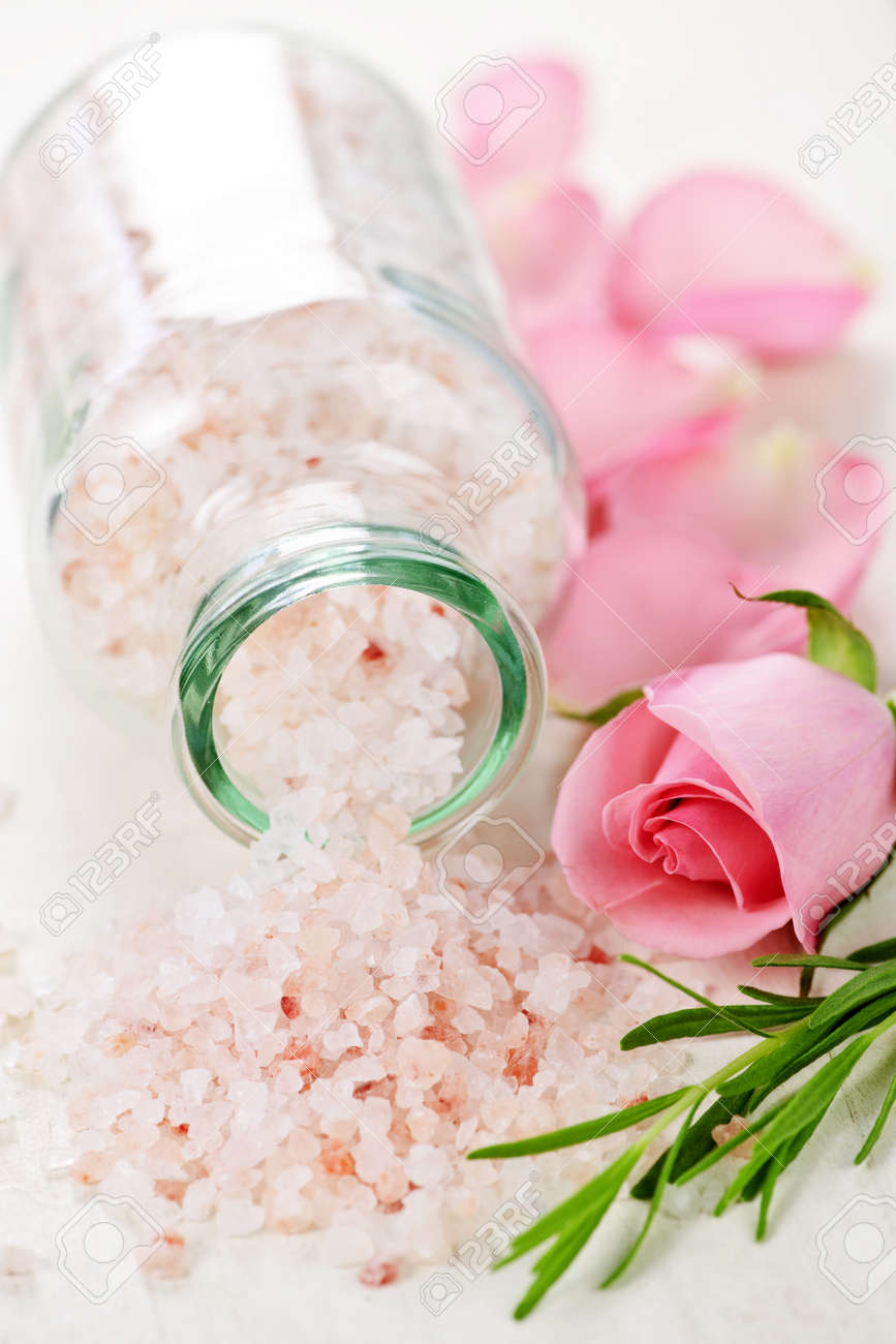 Pink bath salts in a glass jar with flowers and herbs - 6856905 Pink bath salts in a glass jar with flowers and herbs - 6856905