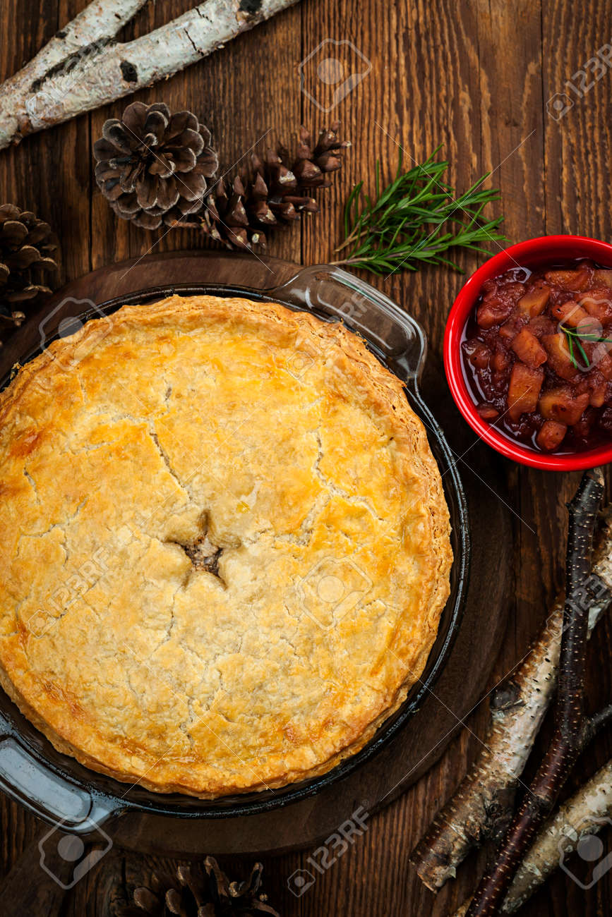 Traditional pork meat pie Tourtiere with apple and cranberry chutney from Quebec, Canada, top view - 27768110 Traditional pork meat pie Tourtiere with apple and cranberry chutney from Quebec, Canada, top view - 27768110