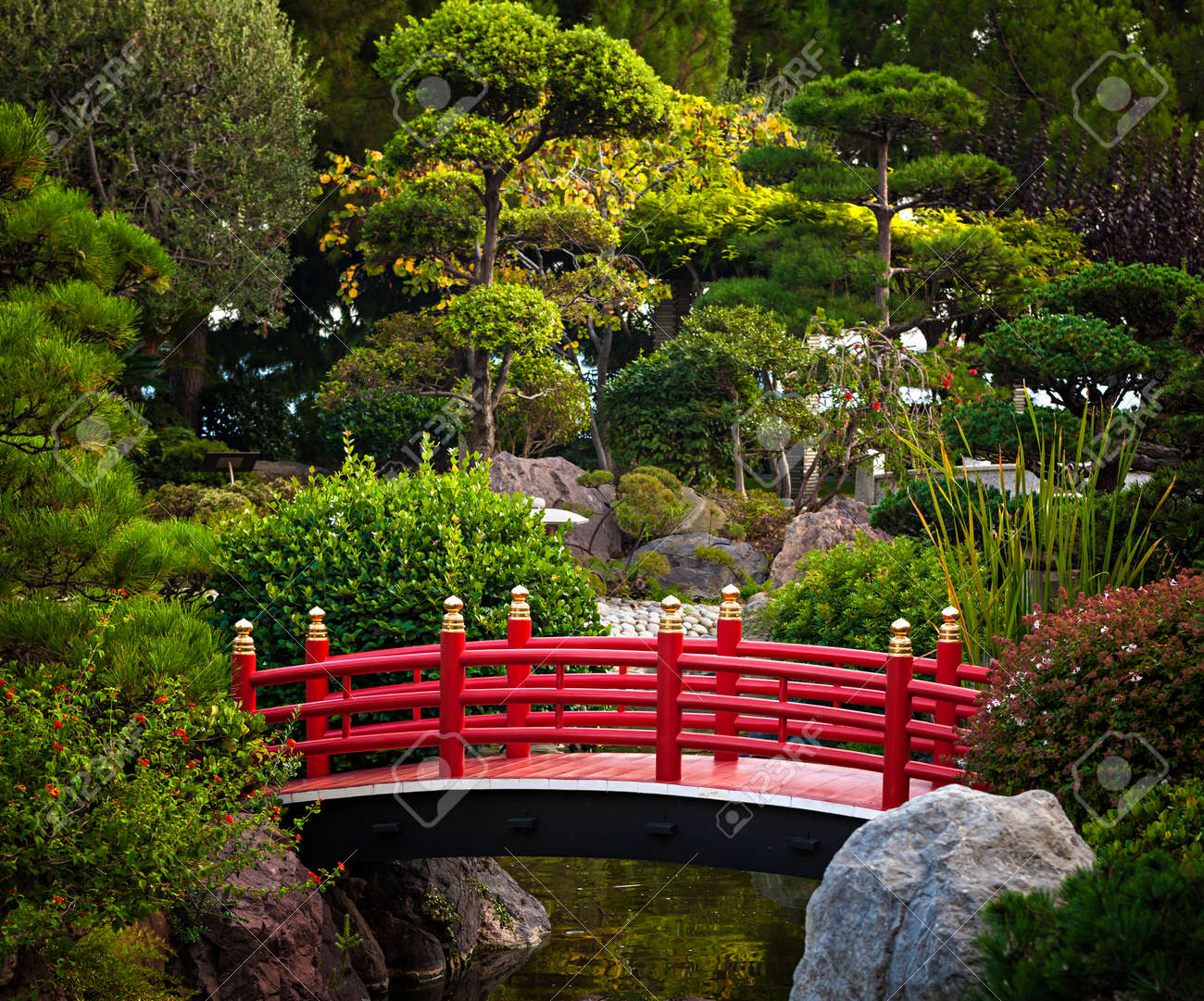 Red Japanese Garden Bridge red bridge over pond in japanese garden. monte carlo, monaco Red Japanese Garden Bridge red bridge over pond in japanese garden. monte carlo, monaco