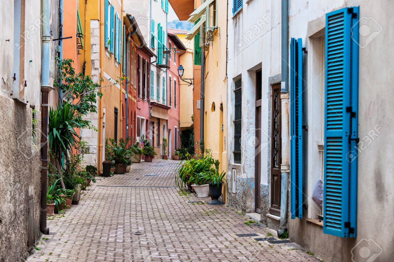 Cobblestone street with colourful buildings and potted plants in old medieval town Villefranche-sur-Mer on French Riviera, France. - 43832352 Cobblestone street with colourful buildings and potted plants in old medieval town Villefranche-sur-Mer on French Riviera, France. - 43832352