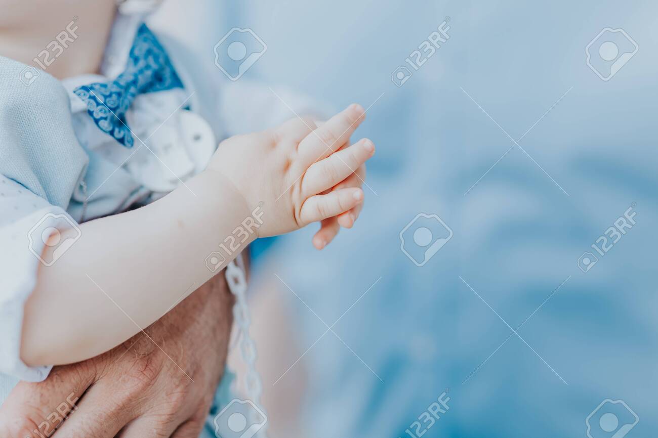 dad holds his son in his arms, a boy in a blue suit - 153446594 dad holds his son in his arms, a boy in a blue suit - 153446594