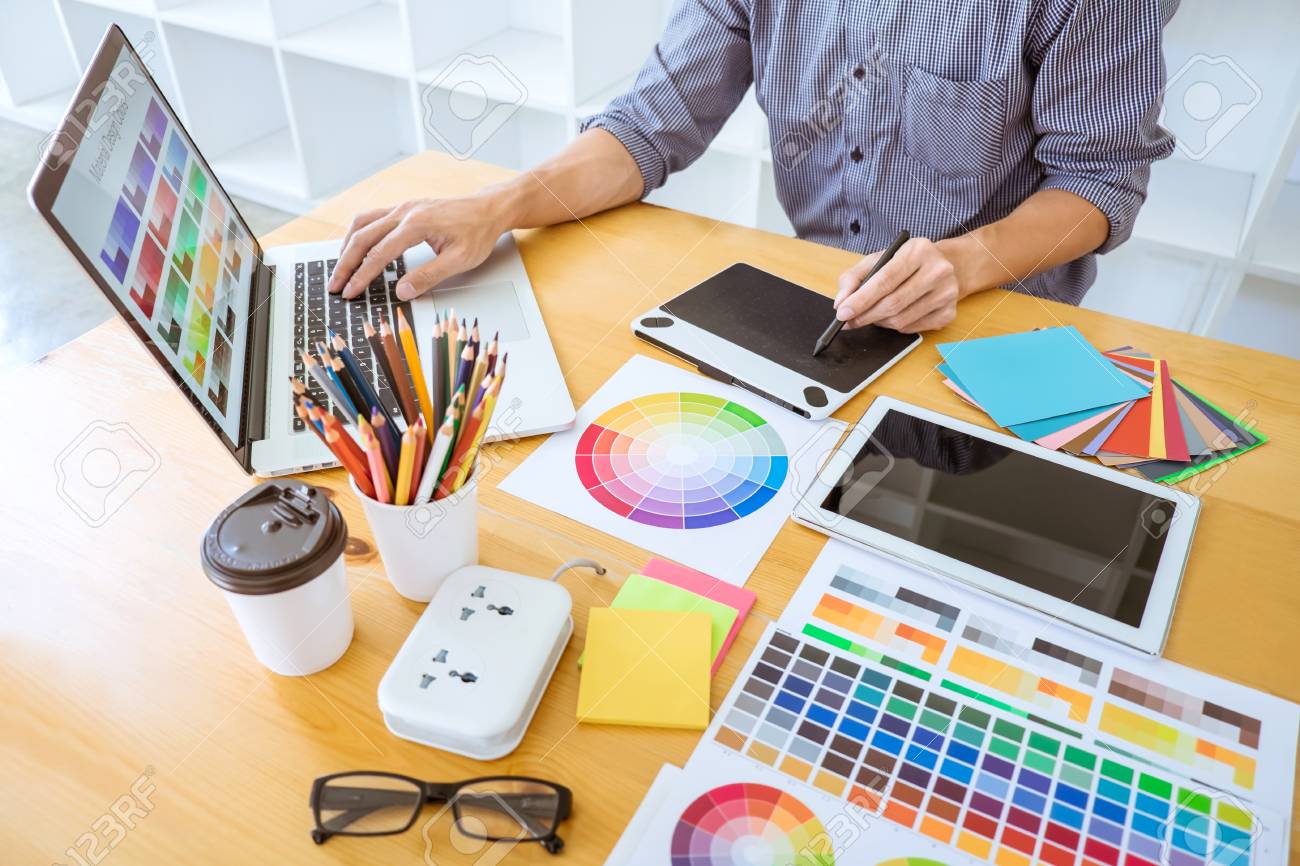 Young Creative Graphic Designer Working On Project Architectural Drawing And Color Swatches, Selection Coloring On Graphic Chart With Work Tools And Equipment. Stock Photo, Picture And Royalty Free Image. Image 112973568.