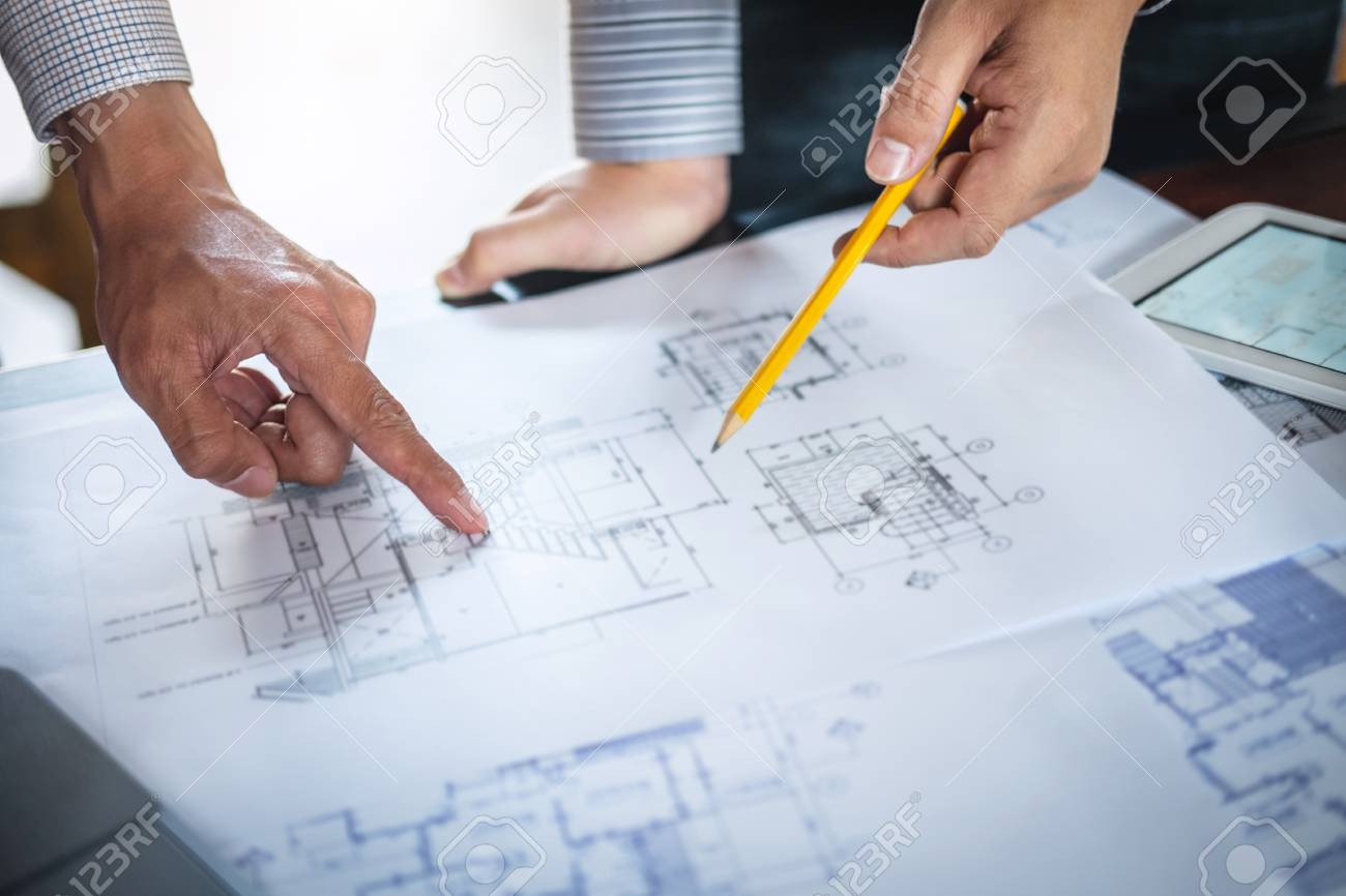 https://previews.123rf.com/images/elleaon/elleaon1906/elleaon190600135/124616795-construction-engineering-or-architect-discussing-a-blueprint-and-building-model-while-checking.jpg