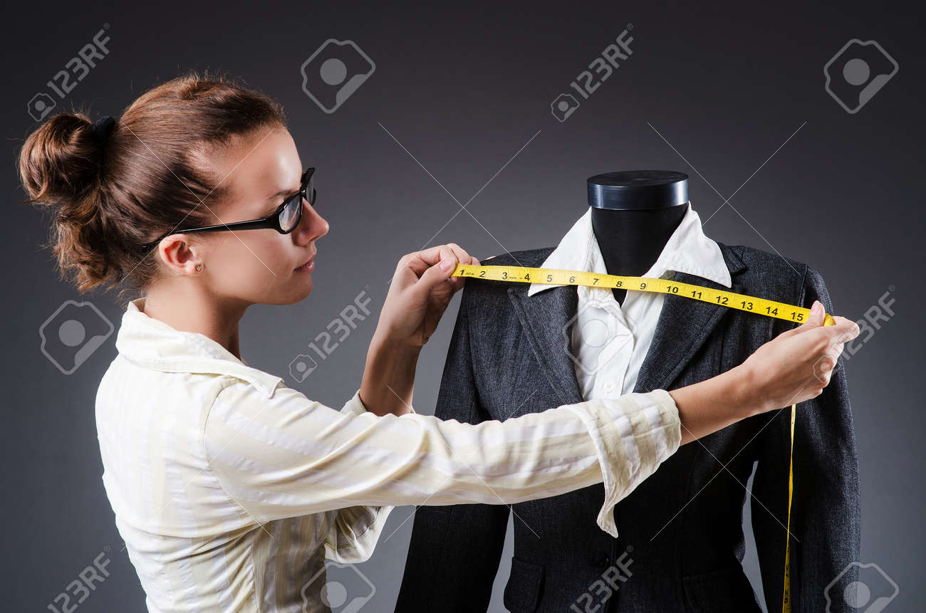 Woman tailor working on clothing - 23082245 Woman tailor working on clothing - 23082245