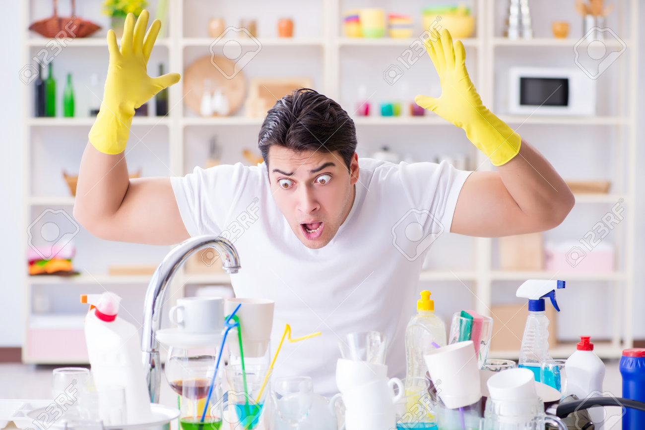 Man frustrated at having to wash dishes - 84127346 Man frustrated at having to wash dishes - 84127346