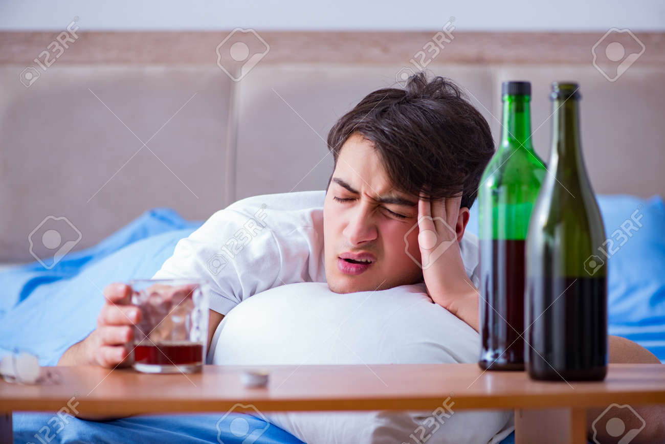89623649-man-alcoholic-drinking-in-bed-going-through-break-up-depression.jpg