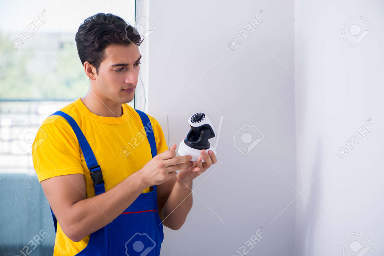 contractor installing surveillance cctv cameras in office construction surveillance technician