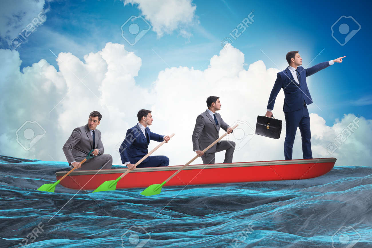 team of businessmen in teamwork concept with boat stock photo