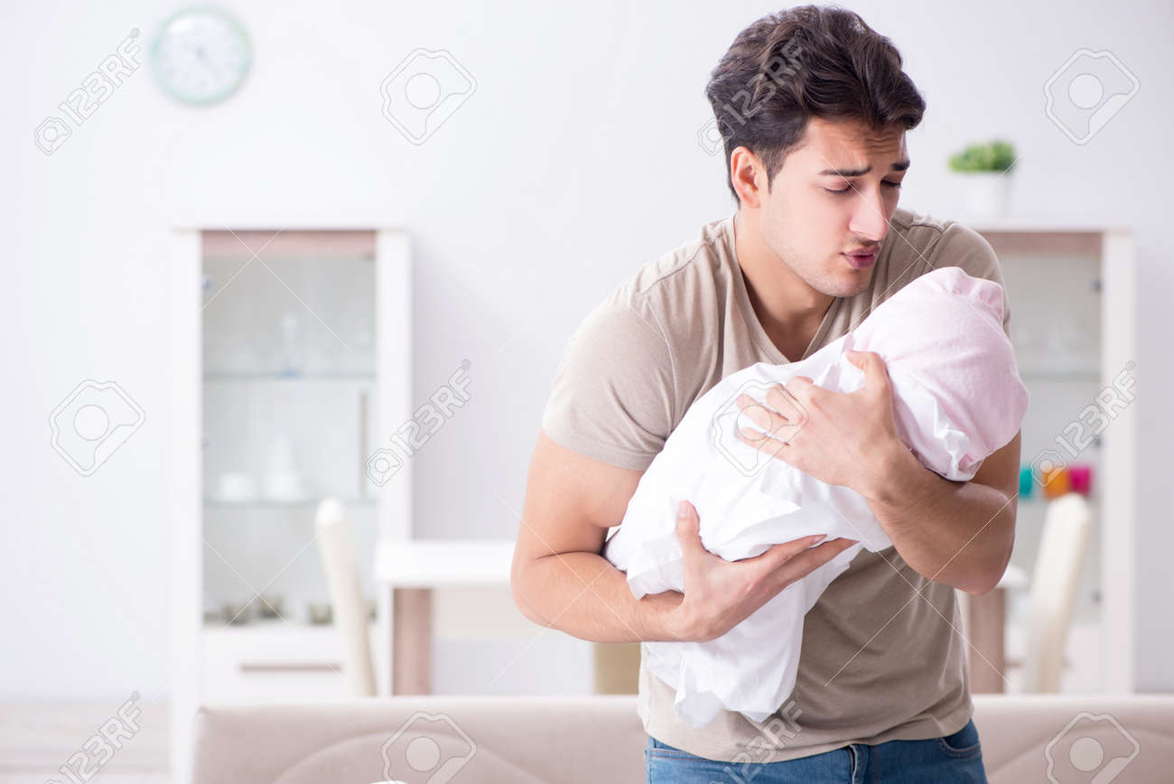 Young father dad frustrated at crying baby - 96669470 Young father dad frustrated at crying baby - 96669470