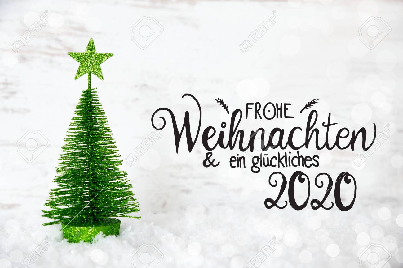 German Calligraphy Frohe Weihnachten Und Ein Glueckliches 2020 Means Merry Christmas And A Happy 2020 One Green Christmas Tree With Star Ornament Lights Background With Snow Stock Photo Picture And Royalty Free